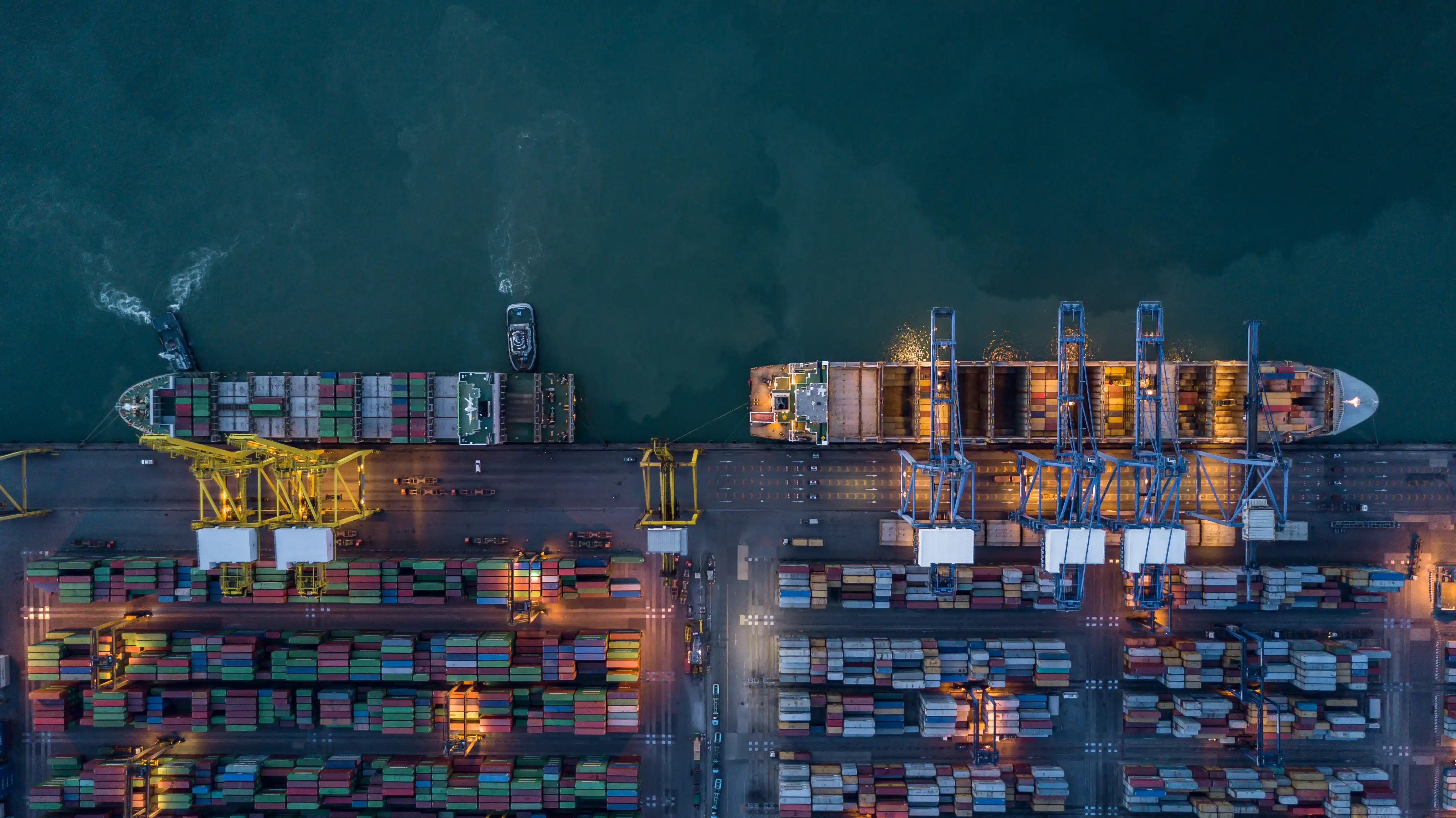 Aerial view of container cargo ship and tugboat